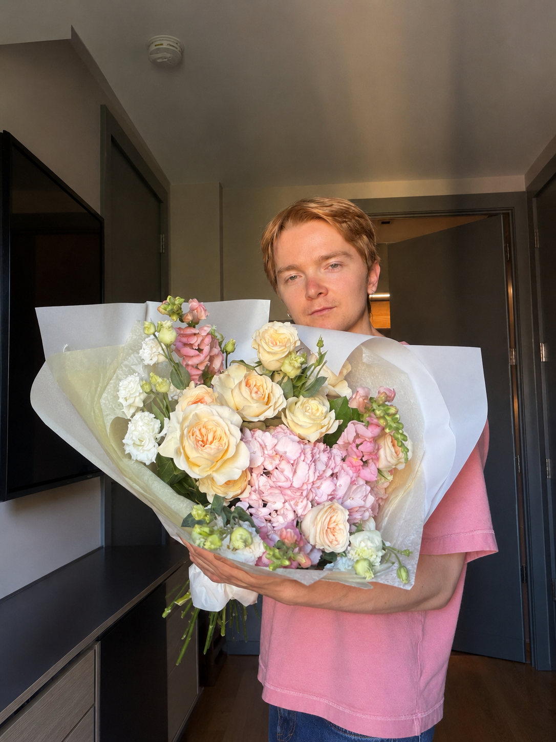 Alex, founder of Ione Florals, holding a bouquet