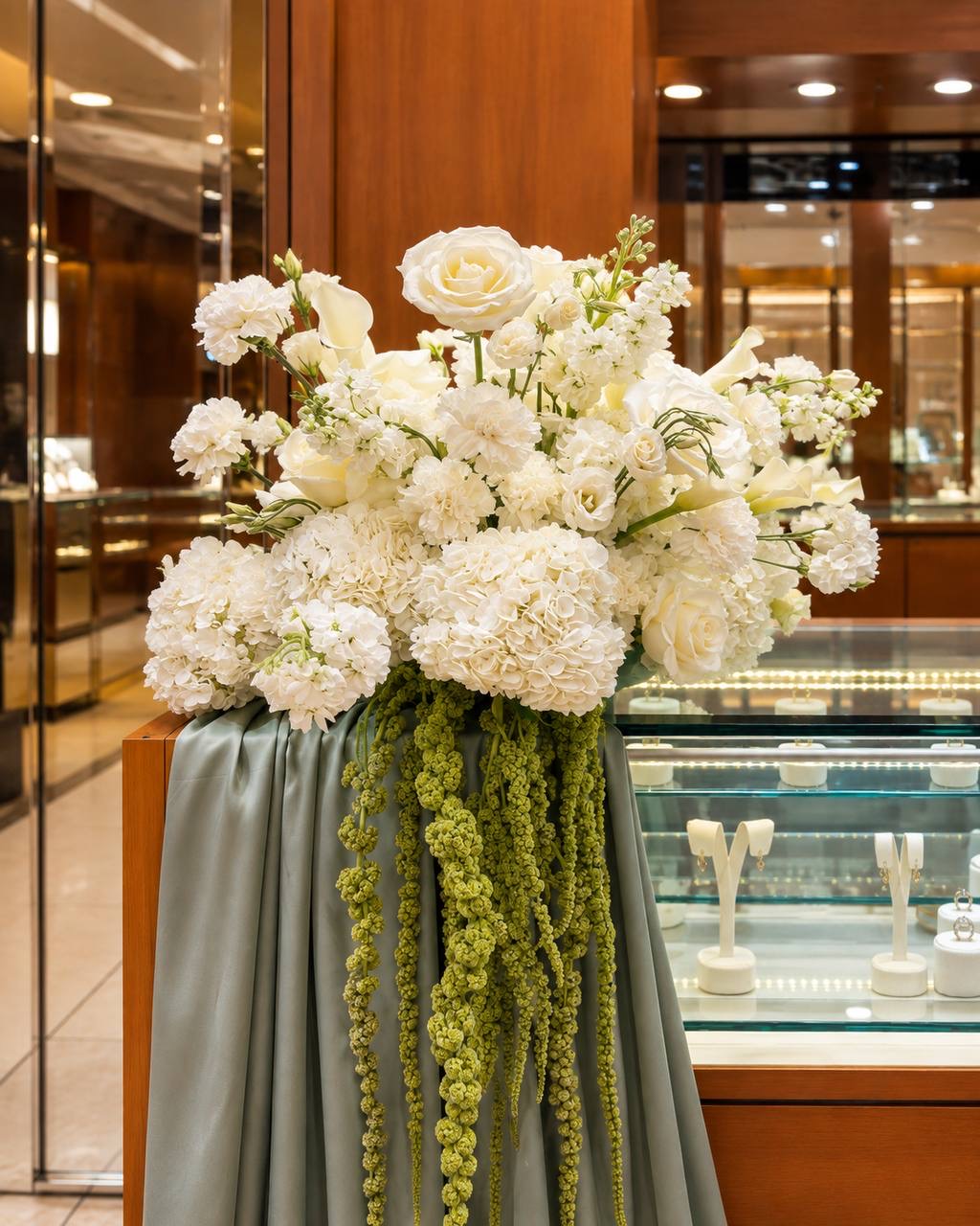 White floral arrangement for a retail space by Ione Florals